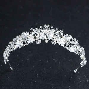 Detailed view of silver bridal crown featuring pearls and sparkling rhinestones