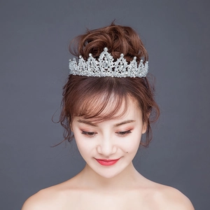 Detailed view of silver bridal crown with shimmering rhinestones and drop-shaped crystal