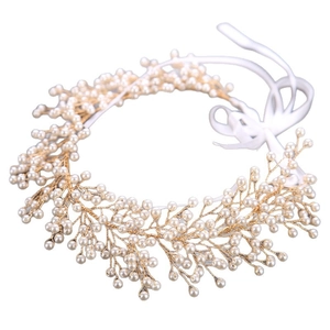 Handmade gold bridal hairband with elegant white pearls and ribbon for wedding hair styling