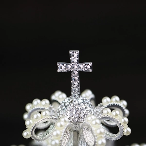 Detailed macro view of crystal cross bridal crown with pearls and rhinestones