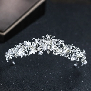 Detailed close-up of a silver bridal crown with crystal rhinestones and white pearls