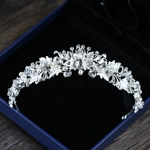 Silver bridal crown with clear rhinestones and white pearls on dark velvet box