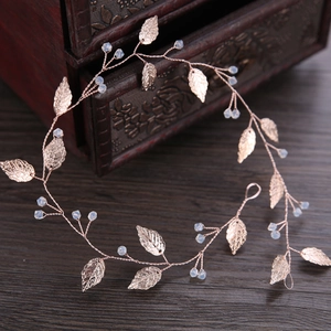 Handmade rose gold bridal leaf headband with blue beads on vintage wooden box