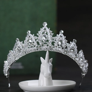 Detailed view of a silver crystal bridal crown on a decorative unicorn jewelry holder