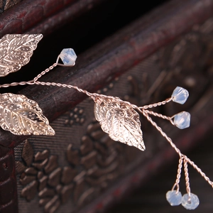 Handmade rose gold bridal headband with metallic leaf patterns and moonstone beads