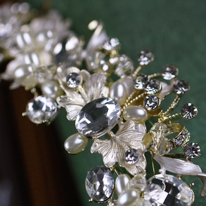 Detailed macro view of vintage gold bridal tiara with sparkling rhinestones and pearls