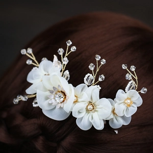 Elegant bridal hair comb with white silk flowers, crystals, and pearls on gold wire
