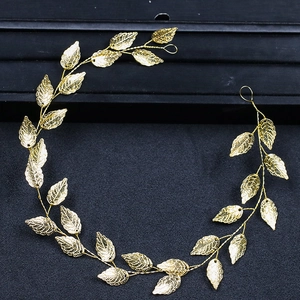 Golden leaf headband for wedding hairstyles featuring delicate metallic foliage detail