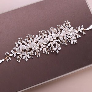 Detail eines Braut-Stirnbands mit weißen Stoffblumen und goldenem Draht mit Kristallen