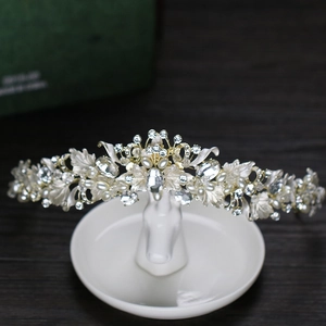 Elegant bridal crown with silver leaves, sparkling crystals and white pearls for wedding