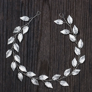 Macro detail of vintage silver leaf hair vine with metallic wire and leaf texture