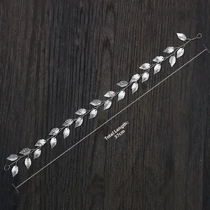 Detailed view of silver leaf bridal hair vine with 37cm length on wooden surface