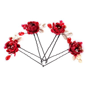 Traditional Chinese bridal hair pins with red fabric flowers and golden metal leaves