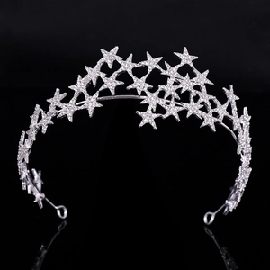 Macro shot of silver bridal tiara featuring rhinestone star patterns with mirror reflection