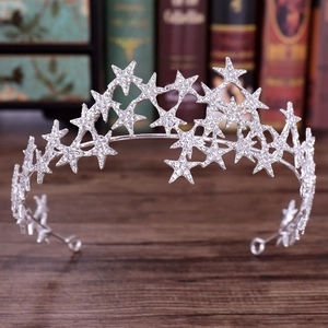 Macro shot of silver bridal crown featuring sparkling rhinestone-encrusted star shapes