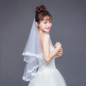 Detail showing white double-layer bridal veil with intricate lace floral embroidery edges