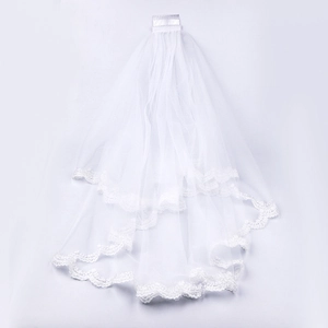 Detailed view of white double-layer bridal veil with lace edges and secure metal comb