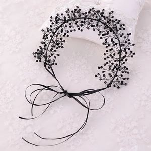 Detail of handcrafted black beaded leaf bridal hairband with elegant satin ribbons