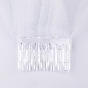 Close-up of a white bridal veil showing the delicate mesh texture and clear plastic hair comb