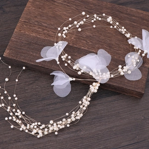 Detail shot of elegant long multi-layer pearl vine hair accessory for bridal headwear