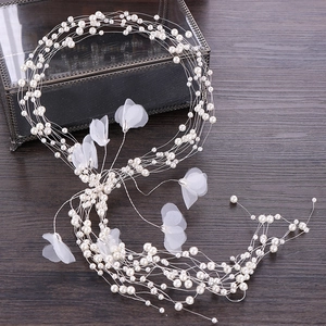 Elegant silver wedding hair vine with white pearls and organza flowers on wood