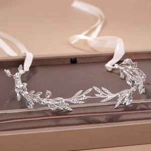 Silver bridal headband featuring crystal leaf vine design and white ribbons for styling