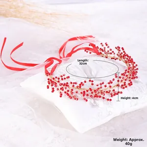 Macro shot of 32cm handmade red beaded bridal headband with golden wire details