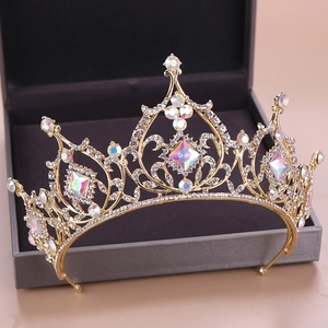Detail of a golden crown with colorful crystals and palace-style metal patterns
