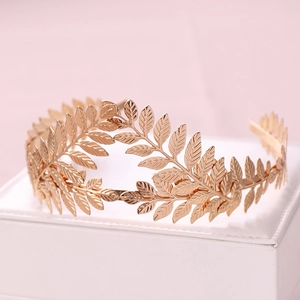 Detailed close-up of golden laurel leaf headband with metallic texture and intricate veins