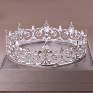 Macro detail of silver fleur-de-lis bridal crown with sparkling diamond accents
