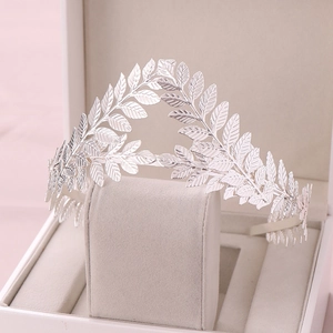 Detailed macro view of silver leaf crown featuring layered laurel leaves and metallic texture