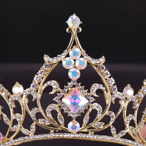 Elegant gold bridal tiara with sparkling crystal rhinestones and iridescent center stone