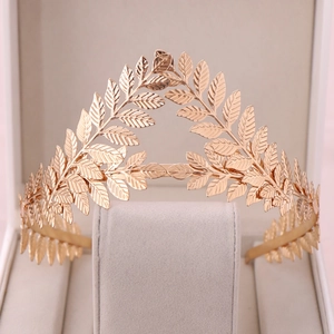 Detailed macro view of vintage rose gold leaf crown with intricate embossed metal texture