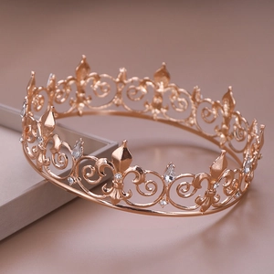 Detail of rose gold bridal crown with intricate filigree and teardrop rhinestones