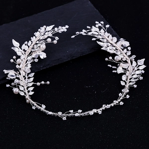 Elegant silver bridal leaf headband with pearls and rhinestones on black rock background