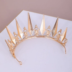 Detailed view of the gold crown featuring geometric spires and vintage hollow patterns