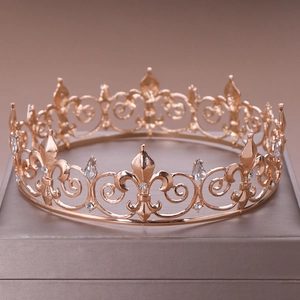 Detail of rose gold bridal crown with fleur-de-lis patterns and teardrop crystals