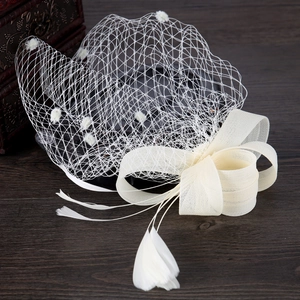 Elegant white mesh bridal fascinator with mesh bow and delicate feather accents