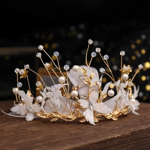 Exquisite gold bridal tiara with white feathers, lace flowers and pearls for wedding