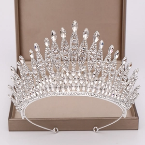 Macro shot of silver bridal tiara featuring teardrop and marquise cut crystals on velvet