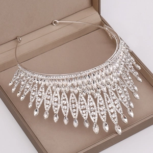 Close-up detail of silver bridal crown with intricate crystal rhinestones in jewelry box