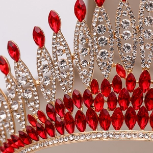 Macro detail of red marquise crystals and clear rhinestones on a gold pageant crown