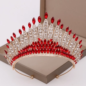 Detail of bridal tiara with red marquise crystals and white diamonds on a gold base
