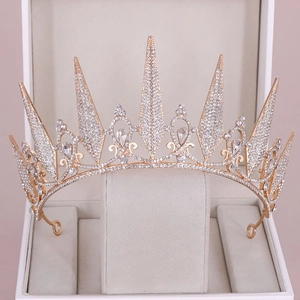 Macro detail of gold bridal tiara with sparkling crystal rhinestones and pointed spikes