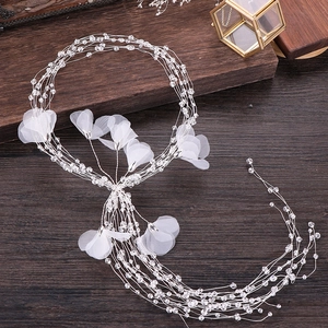 Elegant long bridal hair vine with white tulle flowers and crystal beads on wood