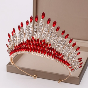 Detail of red crystals and white rhinestones set in a luxury gold tiara headpiece