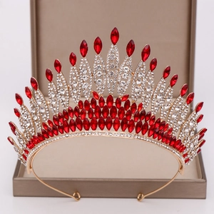 Detailed macro view of large bridal crown with red gems and crystals on a luxury jewelry box