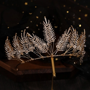 Handmade golden bridal crown with crystal leaf designs and sparkling rhinestone details