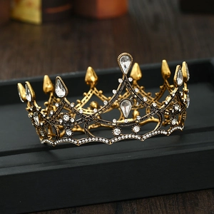 Detailed macro of golden baroque crown with sparkling crystals and drop rhinestones