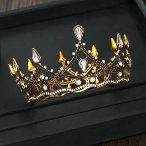 Detailed view of vintage baroque crown with clear crystals and antique gold finish metal